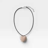 JONES + CO sculptural shell-inspired heart pendant necklace on black leather cord. Acrylic material.