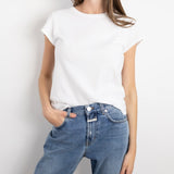 JONES + CO Sheryl baby tee in white organic cotton worn by a model with blue jeans