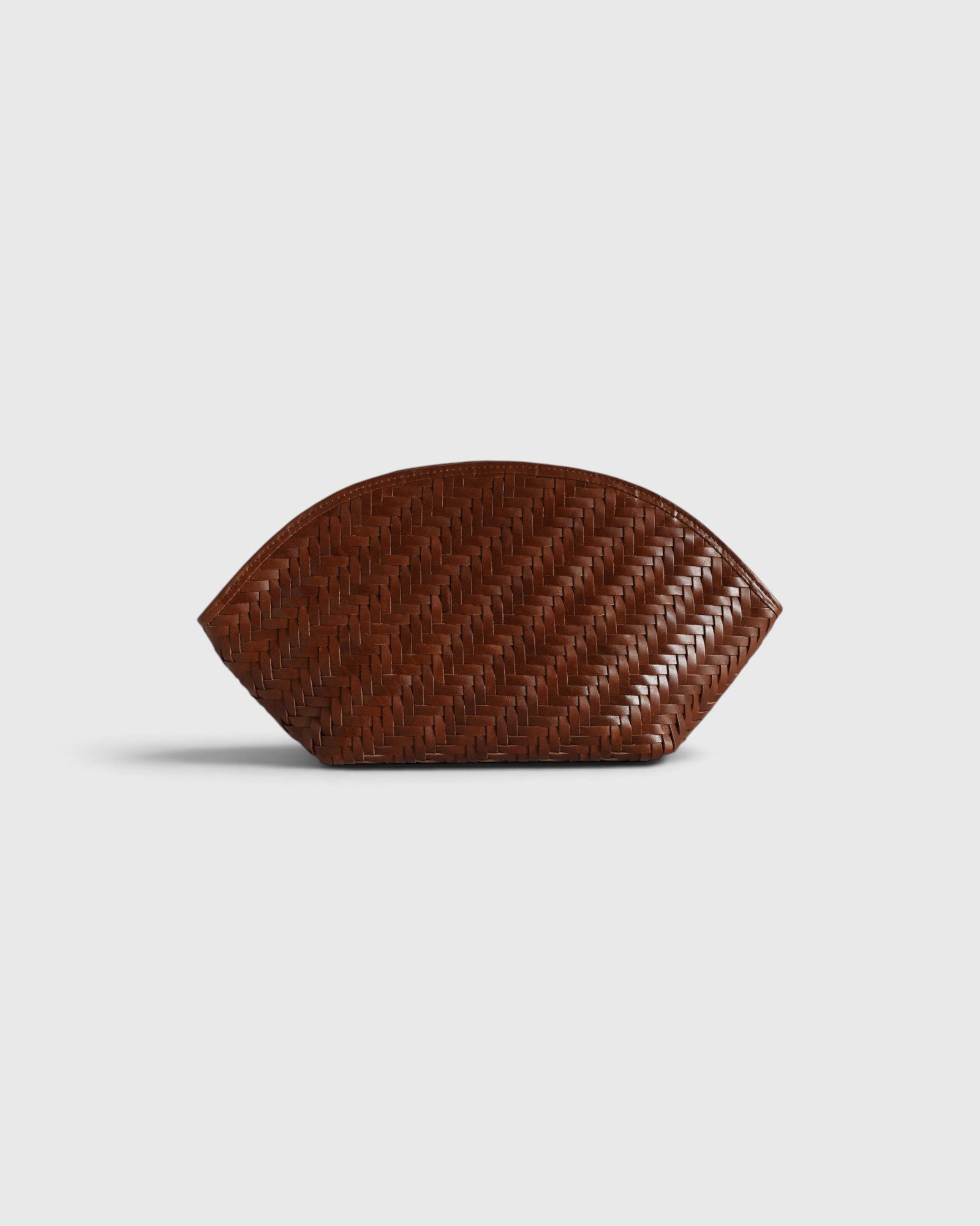 JONES + CO Elin sienna brown calfskin pouch featuring a woven braided pattern and a secure zip closure