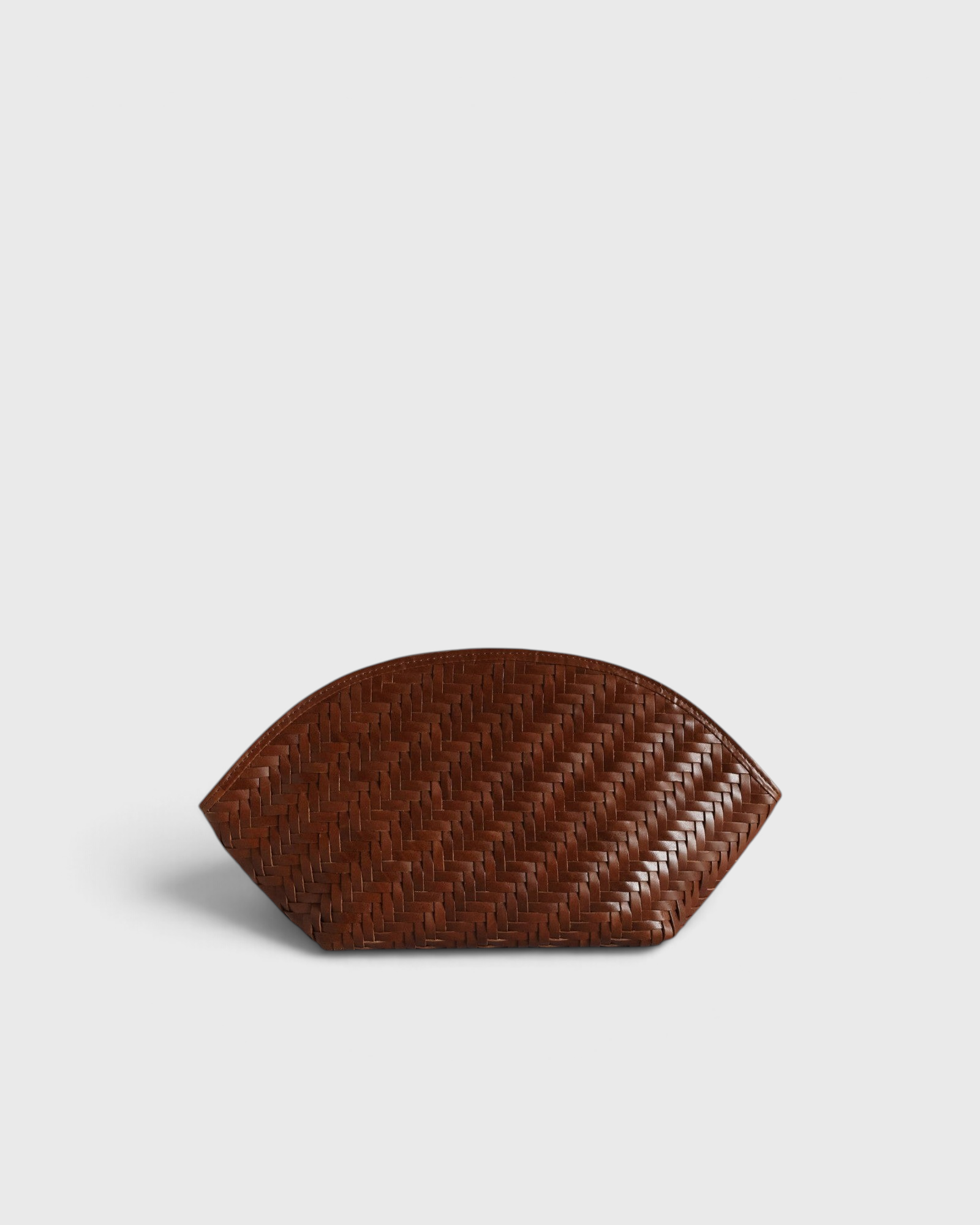 JONES + CO Elin sienna brown calfskin pouch featuring a woven braided pattern and a secure zip closure