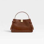 JONES + CO Gyoza Mini handbag in sierra brown embossed Italian leather with gold-tone hardware and top handle.