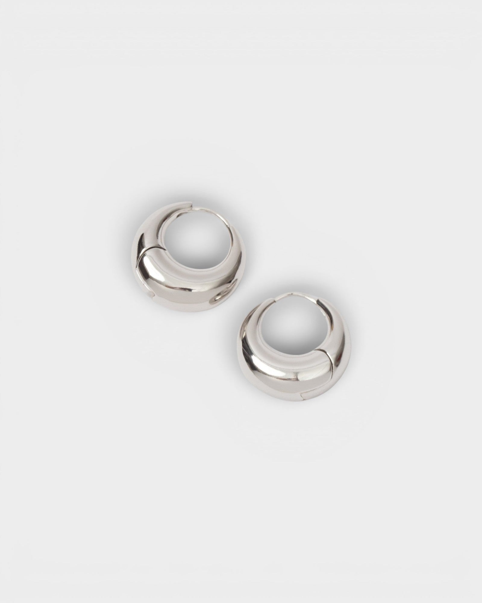 JONES + CO silver-plated brass Alpha Hoop huggie earrings with a chunky tapered design and hinge closure.