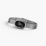 JONES + CO Jane Small watch with a silver woven mesh bracelet and a compact oval black dial.