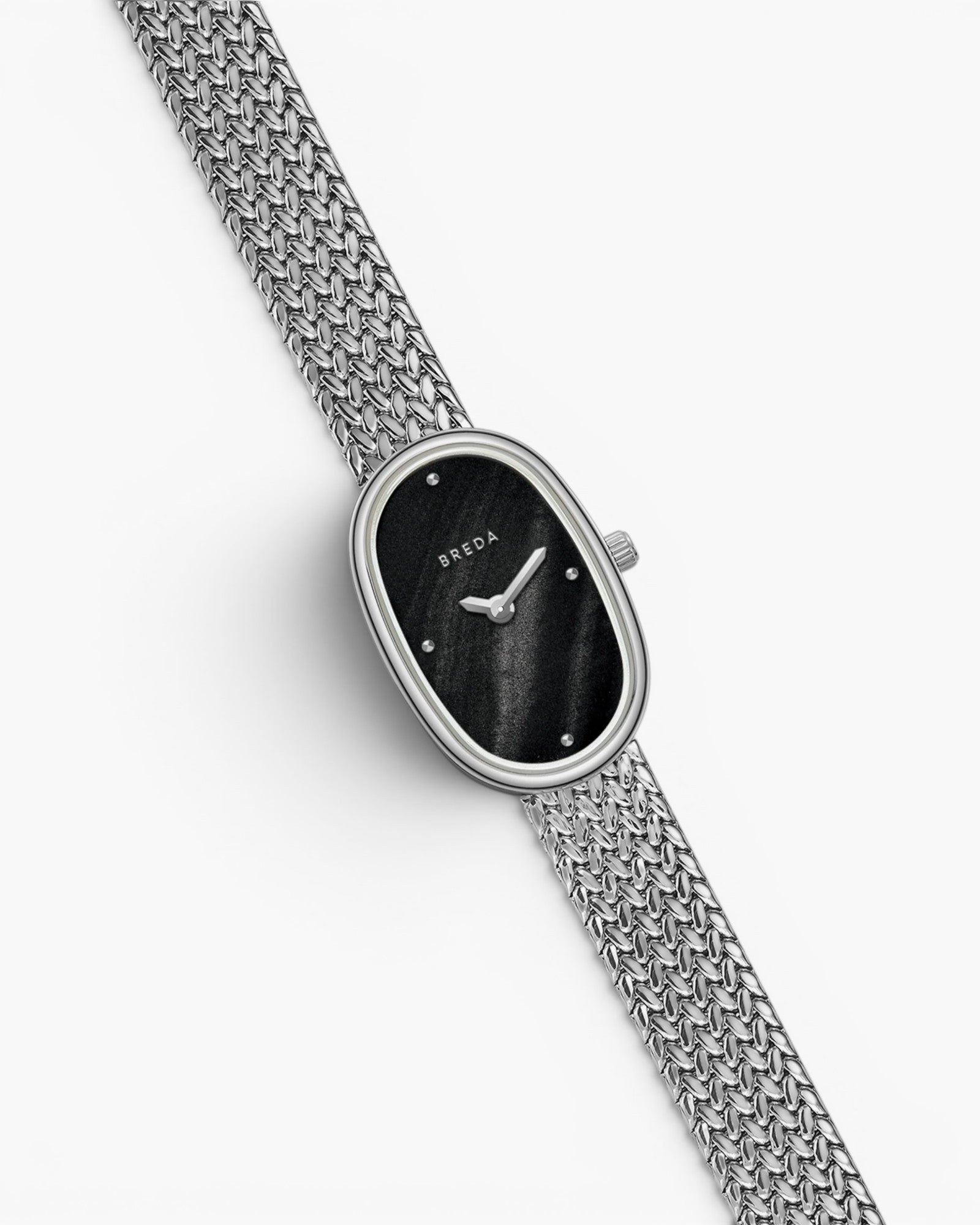 JONES + CO Jane Small watch with a silver woven mesh bracelet and a black oval dial on a white background.