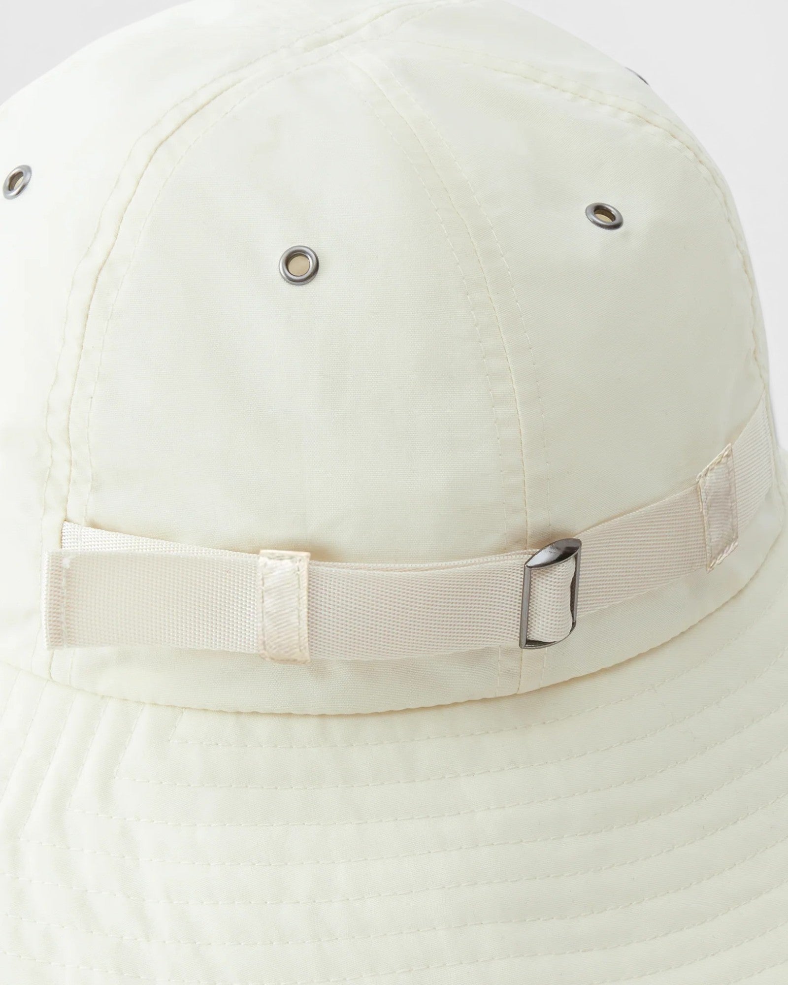 JONES + CO Skipper Hat in Bone, a packable sun hat made from 100% recycled nylon with adjustable strap and metal buckle.