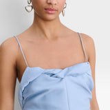 JONES + CO sky blue Priss dress featuring slim straps and a draped neckline detail on a model.