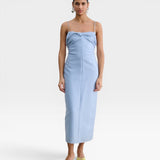 JONES + CO sky blue Manon wool midi dress with slim straps, draped neckline, and fitted waist on a model.