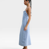 JONES + CO sky blue Manon wool midi dress with slim straps, draped neckline, and low-cut back on a model