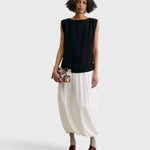 Model holding a JONES + CO Small Hinge Clutch with a colorful abstract floral watercolor print and structured design.