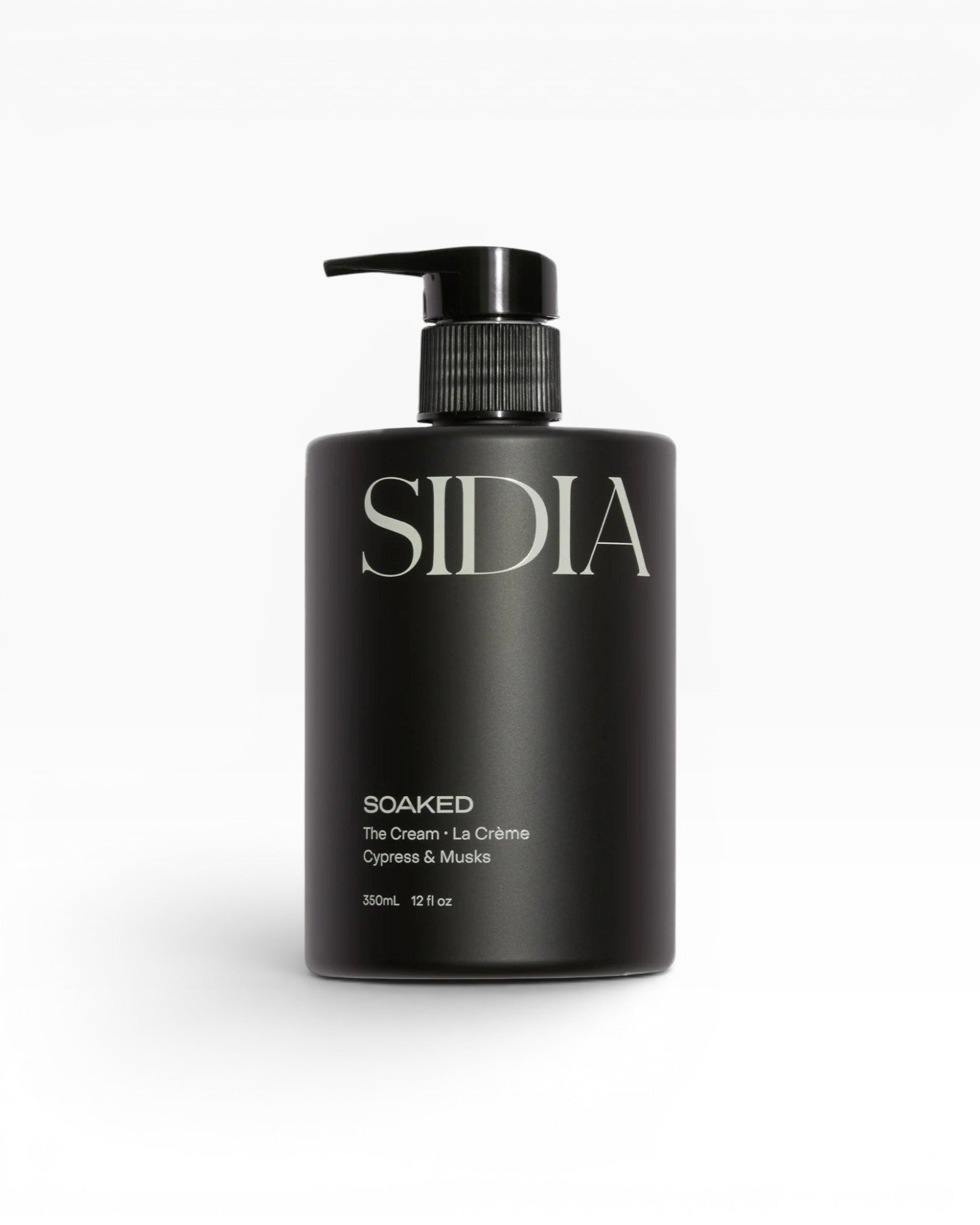JONES + CO SOAKED The Cream La Crème in Cypress & Musks, a black pump bottle with white text.