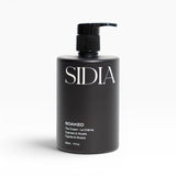 JONES + CO SOAKED The Cream hand and body lotion with Juniper, Cypress, and Musks. Black pump bottle.