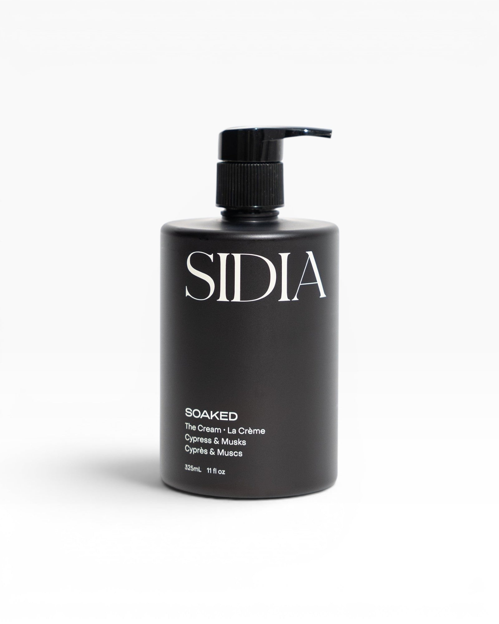 JONES + CO SOAKED The Cream hand and body lotion with Juniper, Cypress, and Musks. Black pump bottle.