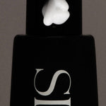 JONES + CO SOAKED Hand Serum with a dollop of white cream on the black pump dispenser.