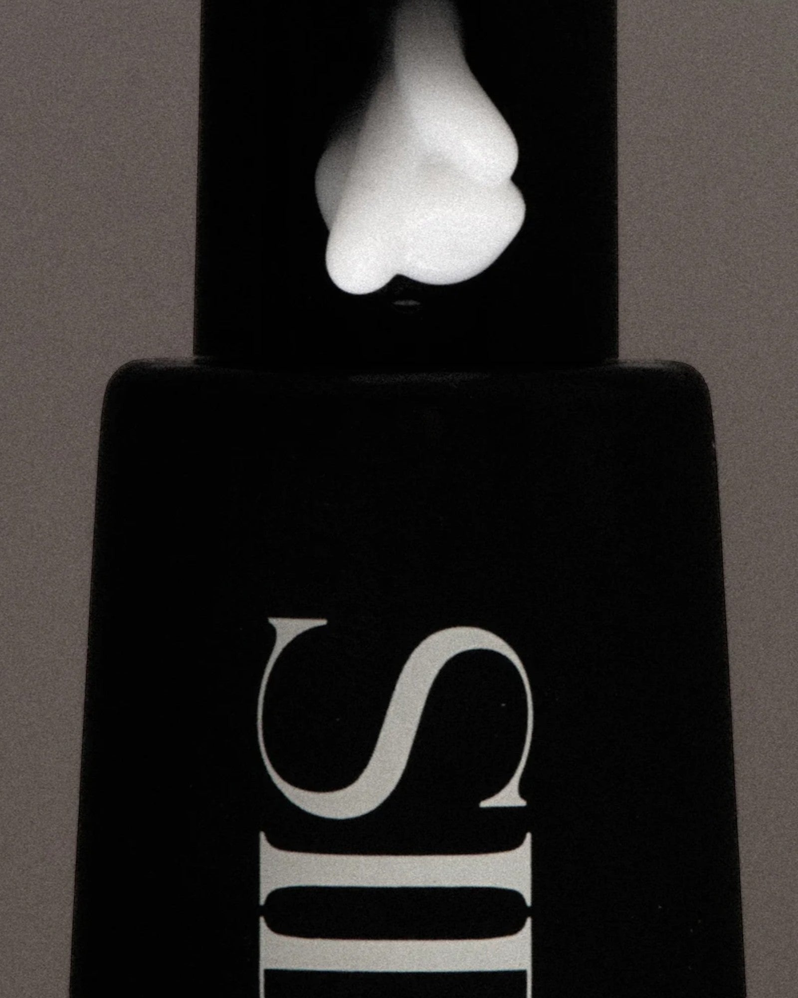 JONES + CO SOAKED Hand Serum with a dollop of white cream on the black pump dispenser.