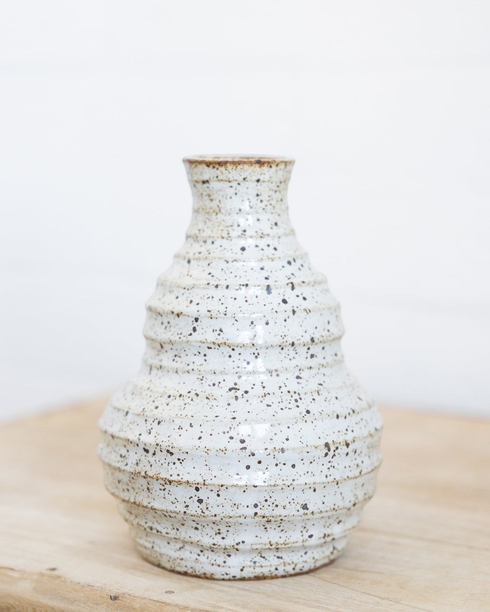 JONES + CO handmade speckled ceramic vessel with sculptural form and soft glaze.