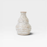 JONES + CO handmade speckled ceramic vessel with ribbed texture and sculptural form, off-white glaze.
