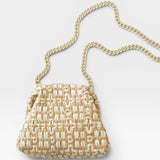 JONES + CO natural woven raffia Stella clutch with a gold chain strap.