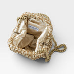 JONES + CO Stella Clutch in natural woven raffia with a satin lining and a tone-on-tone chain strap.