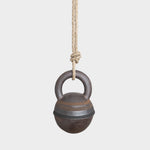 JONES + CO XS stoneware jingle bell with hand-painted black and brown rings, hanging from a natural hemp rope.