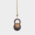 JONES + CO round stoneware jingle bell in extra dark finish with a yellow sun design, hanging from a hemp rope.