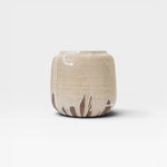 JONES + CO handcrafted stoneware pot with smooth cylindrical shape, beige finish, and natural white glaze drips.