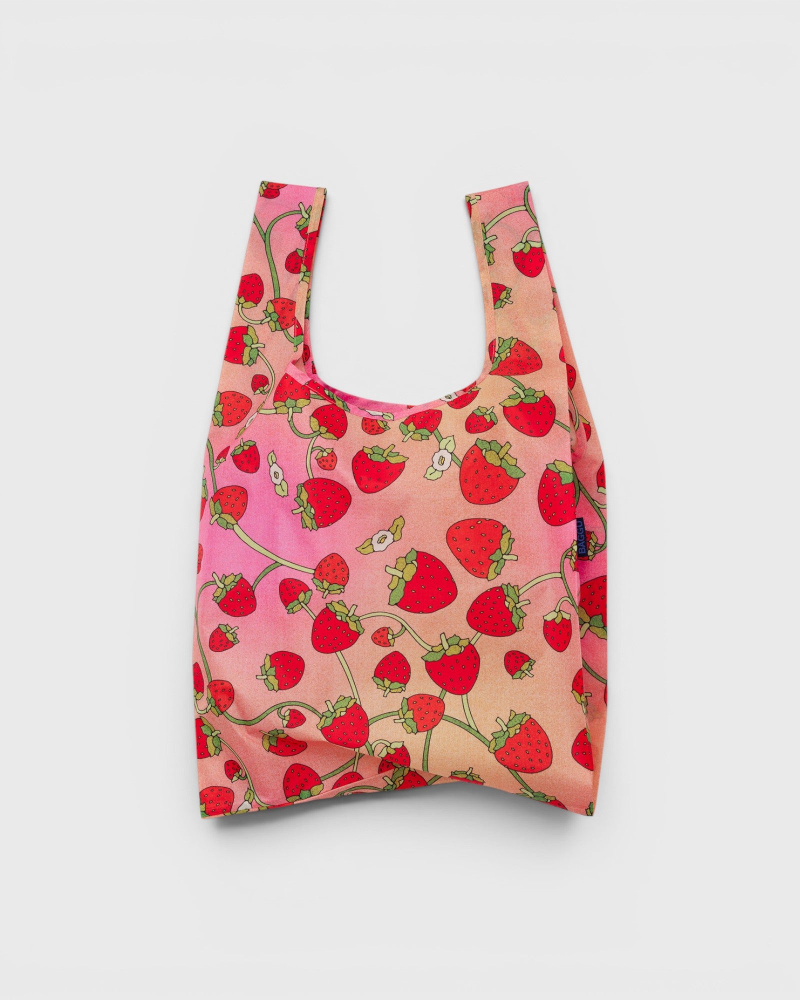 JONES + CO Baggu reusable grocery bag in pink and red strawberry blossom print made from durable ripstop nylon