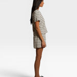 Model wearing JONES + CO natural and chocolate striped loop terry short sleeve shirt and matching shorts side view