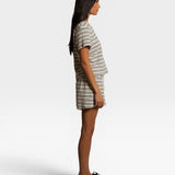 Model wearing JONES + CO natural and chocolate striped loop terry short sleeve shirt and matching shorts side view