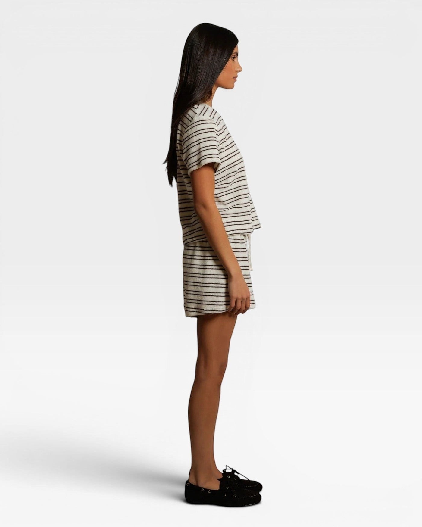 Model wearing JONES + CO natural and chocolate striped loop terry short sleeve shirt and matching shorts side view