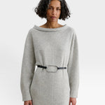 JONES + CO Studded Cole Belt in black leather with an oversized oval buckle worn over a grey knit dress