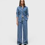 JONES + CO Tali-X mid blue denim jeans with high waist, wide leg, and signature curved seaming on a model