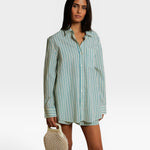 JONES + CO Avalon teal blue and sugar stripe cotton poplin button-down shirt worn by a model with a beaded bag