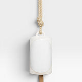 JONES + CO Thrown Bell - Domino Indigo, white ceramic bell with oval inlay, hanging from jute rope.