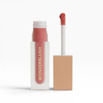 JONES + CO La Laque Tinted Lip Oil in a peachy-pink shade. Sheer, luminous color with a nourishing balm-like texture.