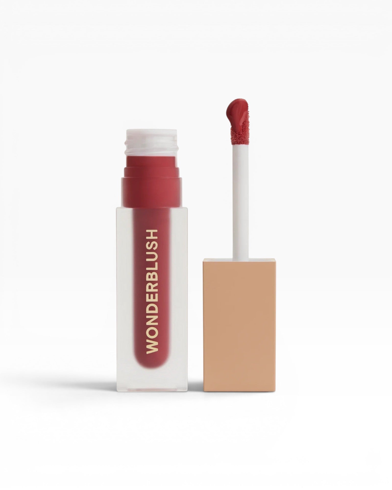 JONES + CO La Laque Tinted Lip Oil in a sheer red shade, with a frosted bottle and gold lettering.