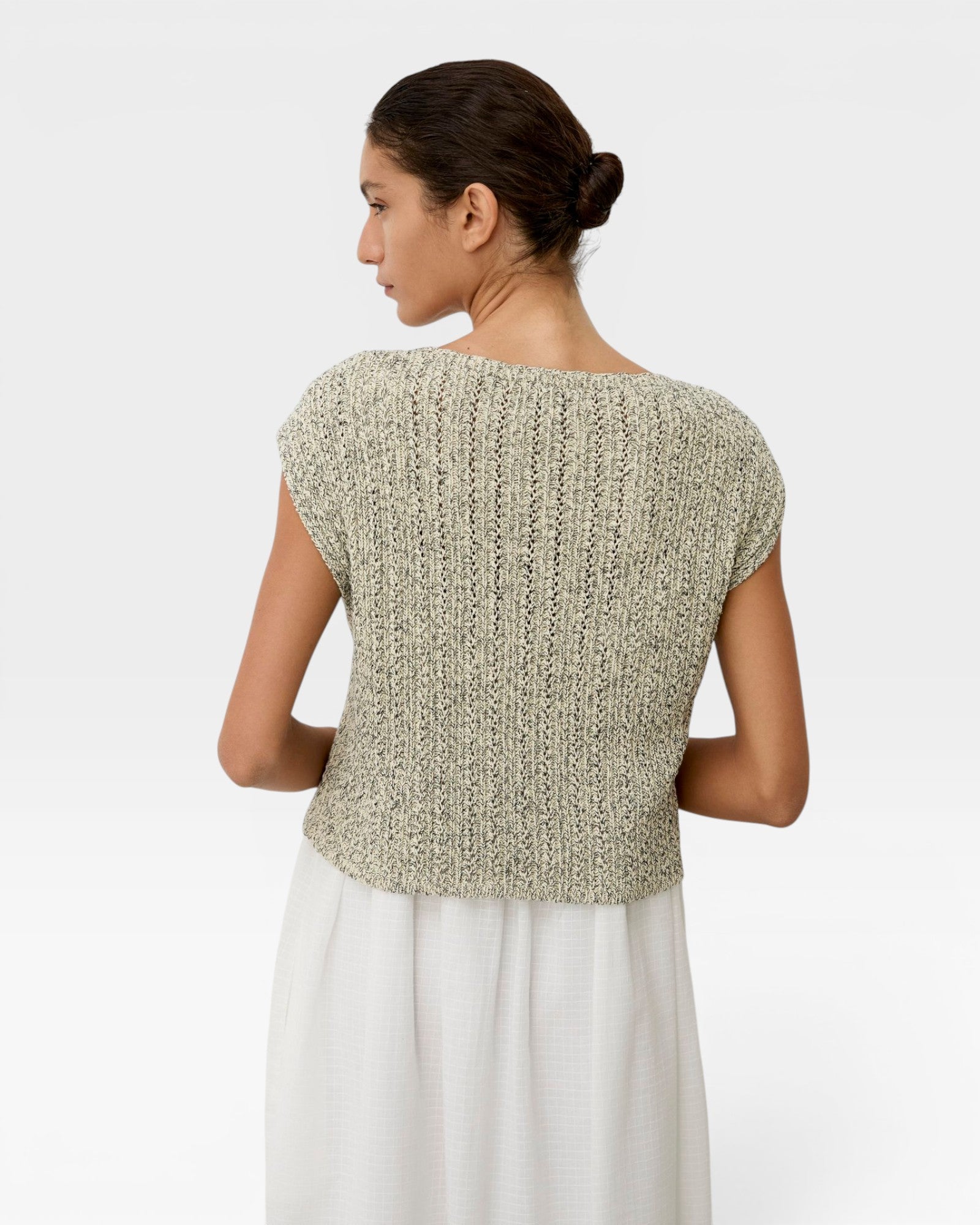 JONES + CO Toledo Top in ecru and black novelty yarn. Relaxed, sleeveless knit with seamless construction and open front hem detail.