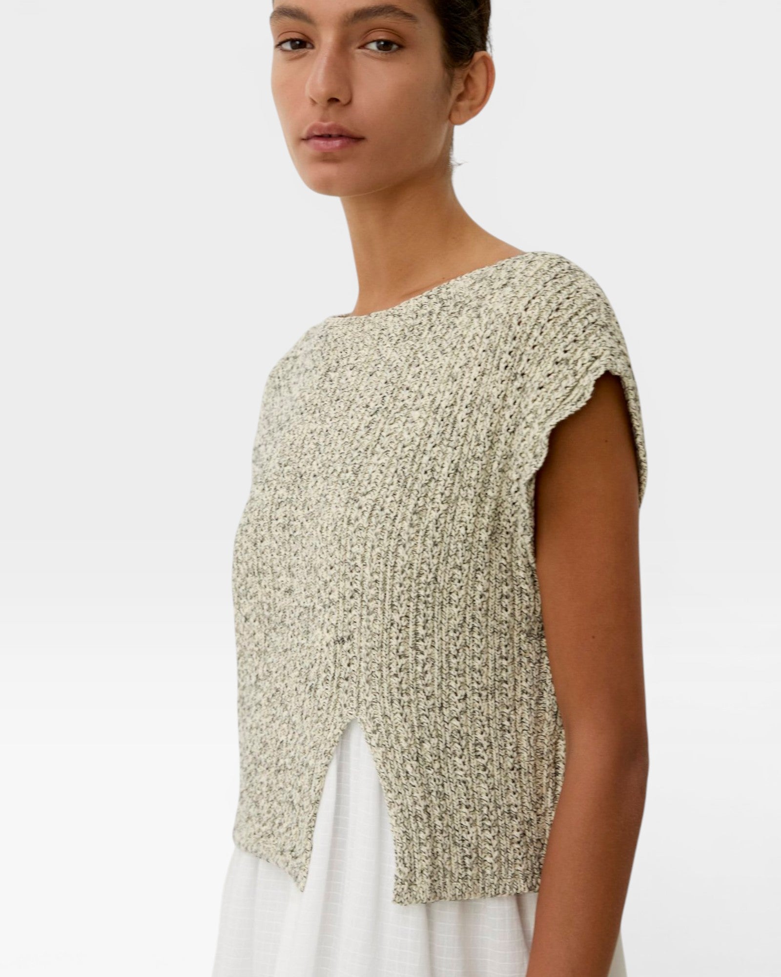 JONES + CO Toledo Top in marble ecru novelty yarn, sleeveless with open front hem detail and seamless construction.