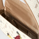 JONES + CO Tommy hand-beaded shoulder bag with dog walk pattern, vegan leather piping, and interior zip pocket.