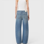 JONES + CO Tori-X barrel jeans in mid blue denim with offset side seams and back pockets, back view on a model.
