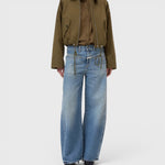 JONES + CO Tori-X barrel jeans in mid blue denim with signature X-pockets and offset side seams on a model.