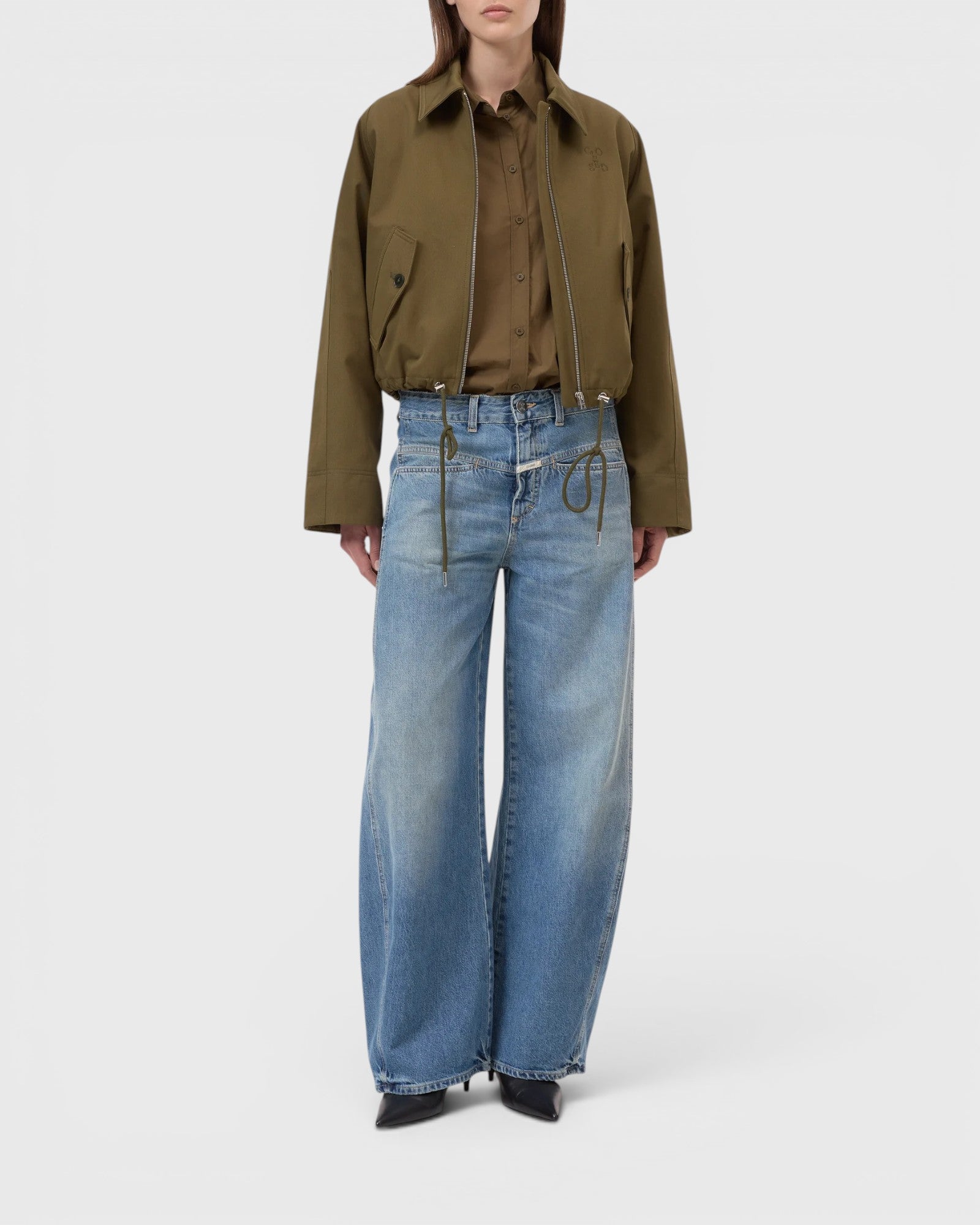 JONES + CO Tori-X barrel jeans in mid blue denim with signature X-pockets and offset side seams on a model.