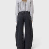 JONES + CO Tori X dark gray barrel fit denim jeans with iconic X-pockets and offset side seams, back view.