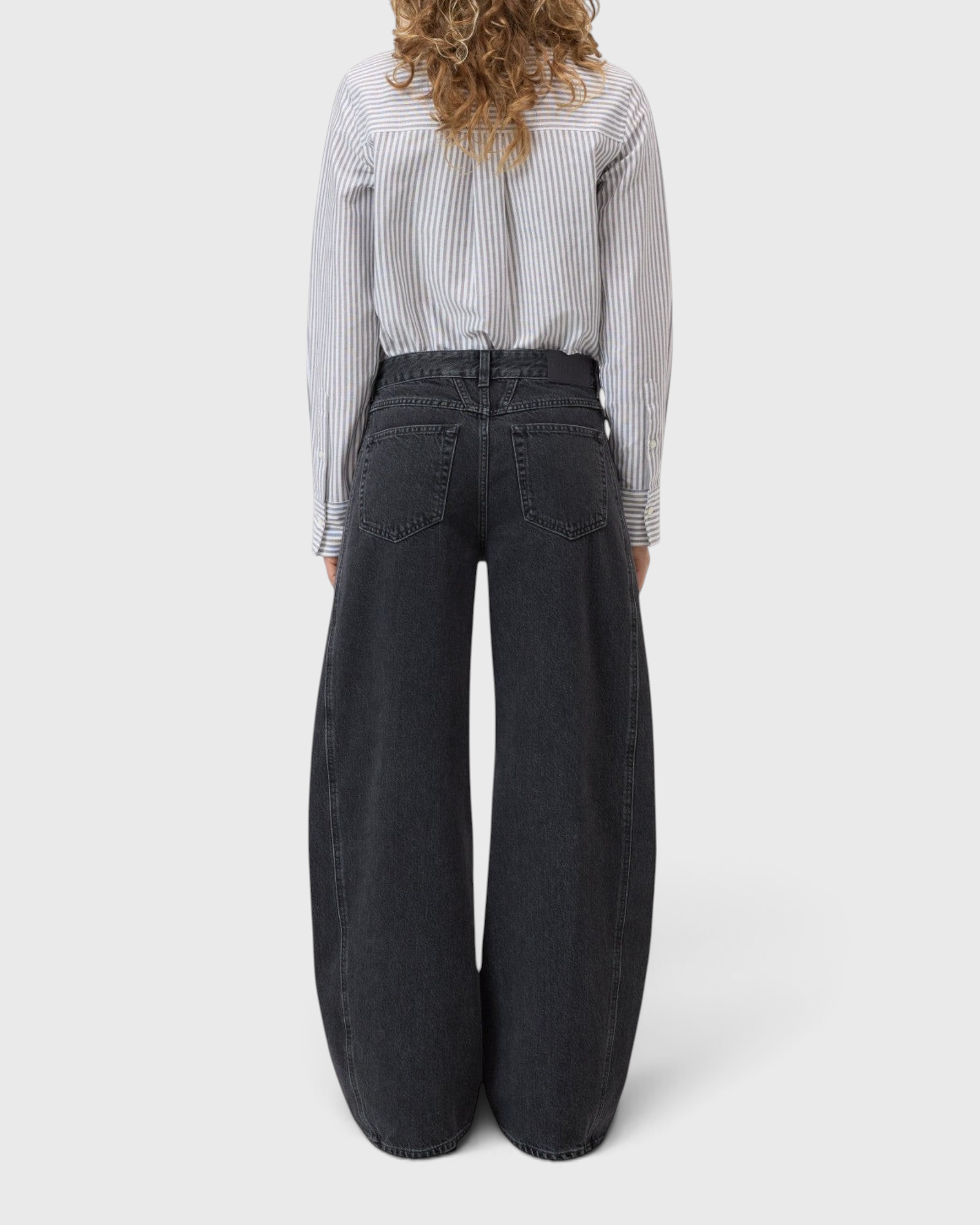 JONES + CO Tori X dark gray barrel fit denim jeans with iconic X-pockets and offset side seams, back view.
