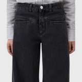 JONES + CO Tori X dark gray barrel fit jeans with mid-rise waist, iconic X-pockets, and offset side seams.