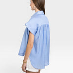 JONES + CO blue brushed cotton Trinity Top with relaxed drape and open collar, worn by a woman.