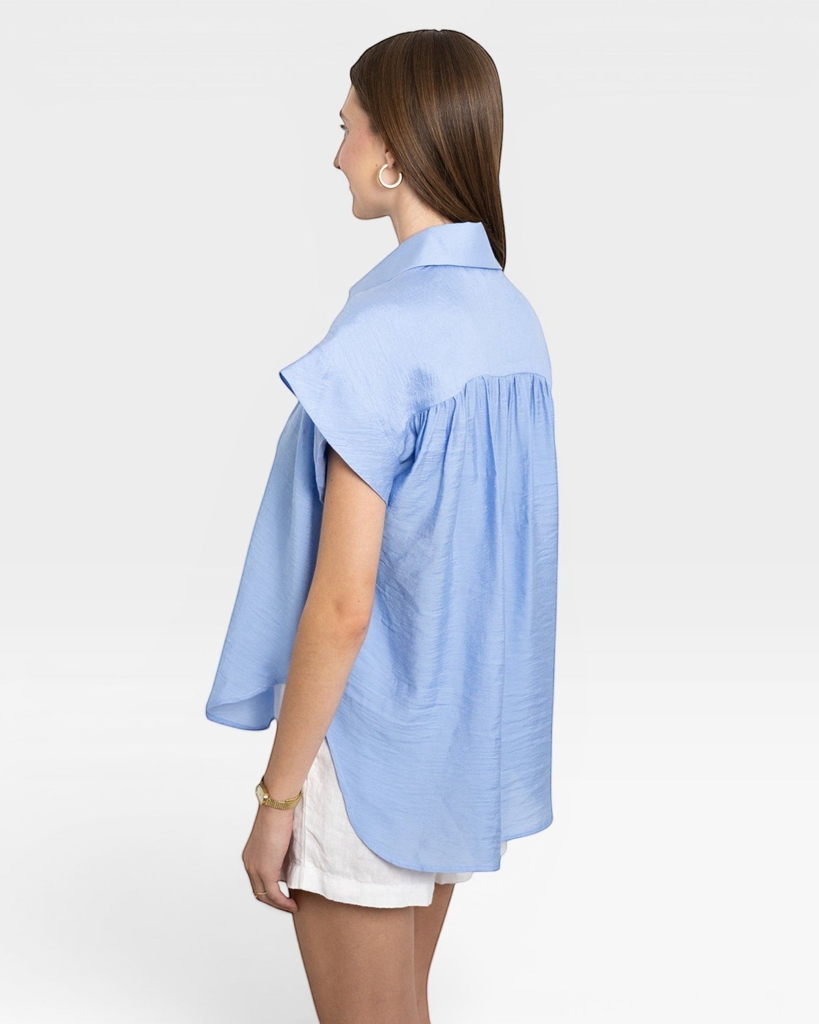 JONES + CO blue brushed cotton Trinity Top with relaxed drape and open collar, worn by a woman.