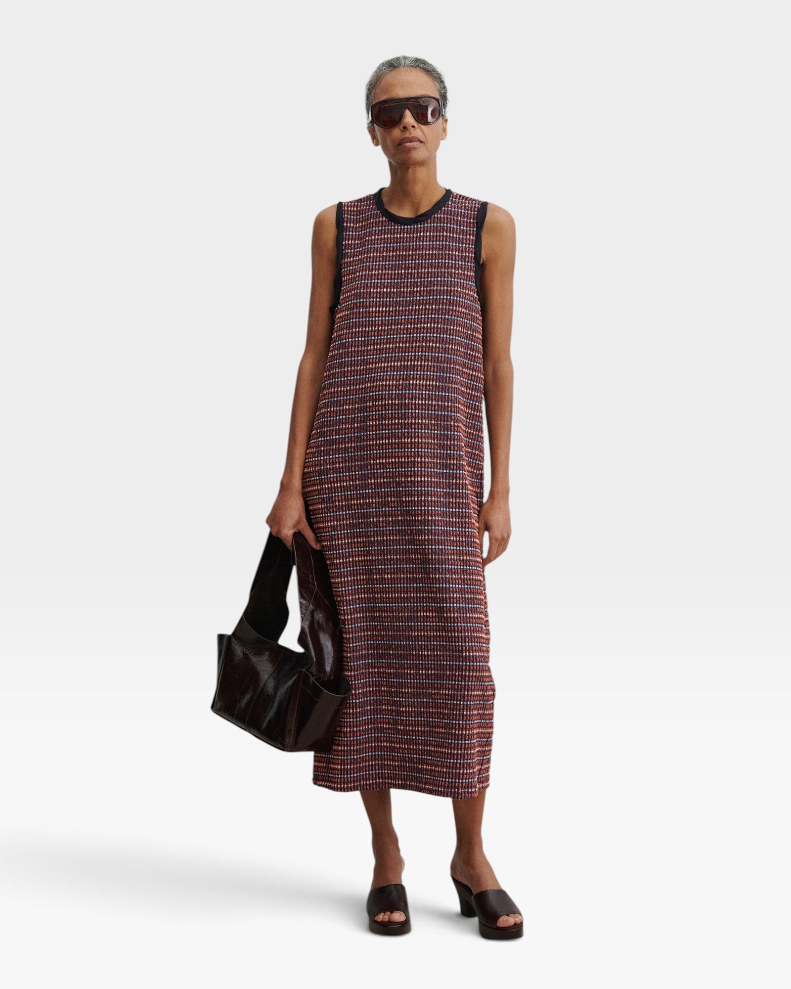 JONES + CO Valley midi dress in russet stretchy check fabric with contrast black binding, worn by a model.