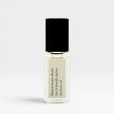 JONES + CO No.15 Vanille Infinie travel size perfume oil in a clear glass rollerball bottle with a black cap.