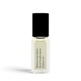 JONES + CO No.15 Vanille Infinie travel size perfume oil in a clear glass rollerball bottle with a black cap.