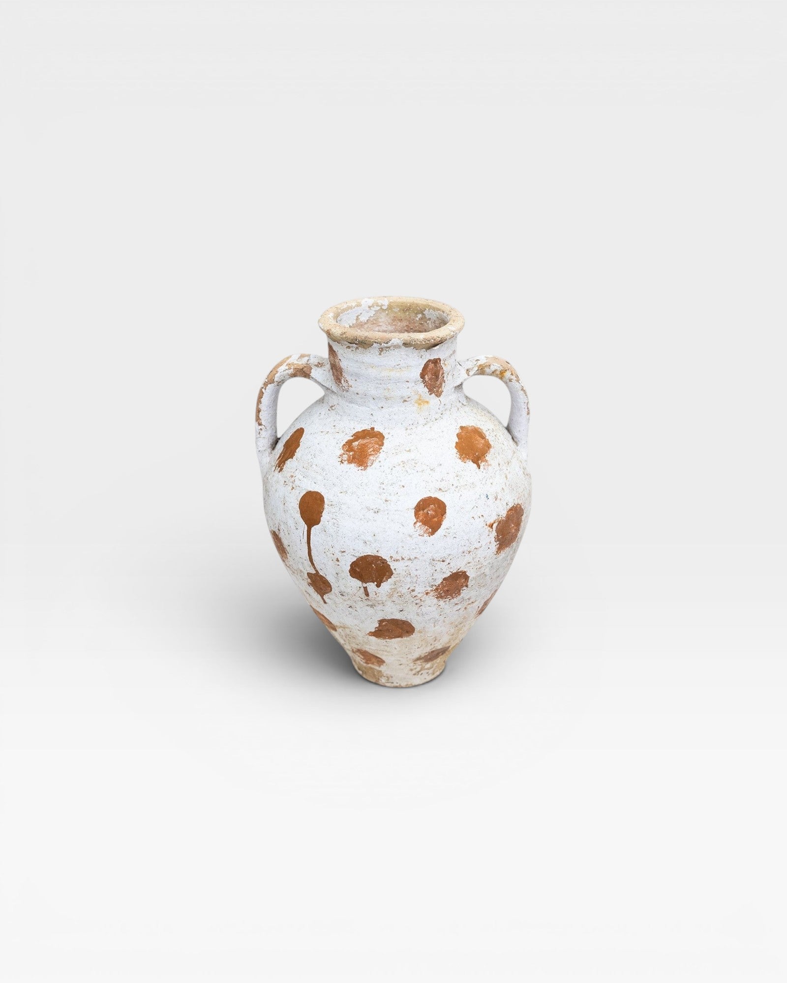 JONES + CO vintage Anatolian olive jar with white limewash and terracotta polka dots. Hand-thrown pottery with aged patina.